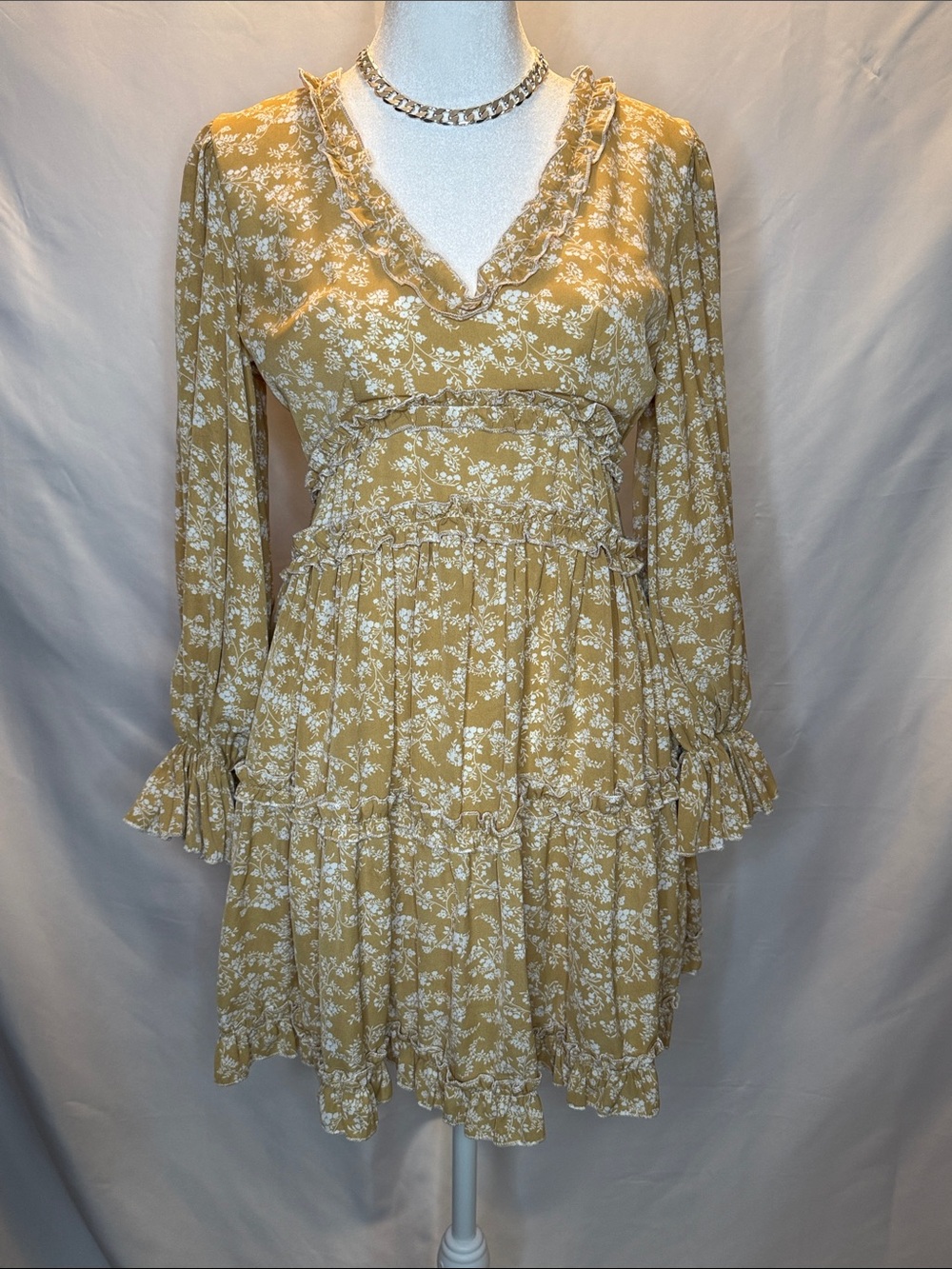 the clothing company Mustard Floral Ruffle Long Sleeve Tiered Dress